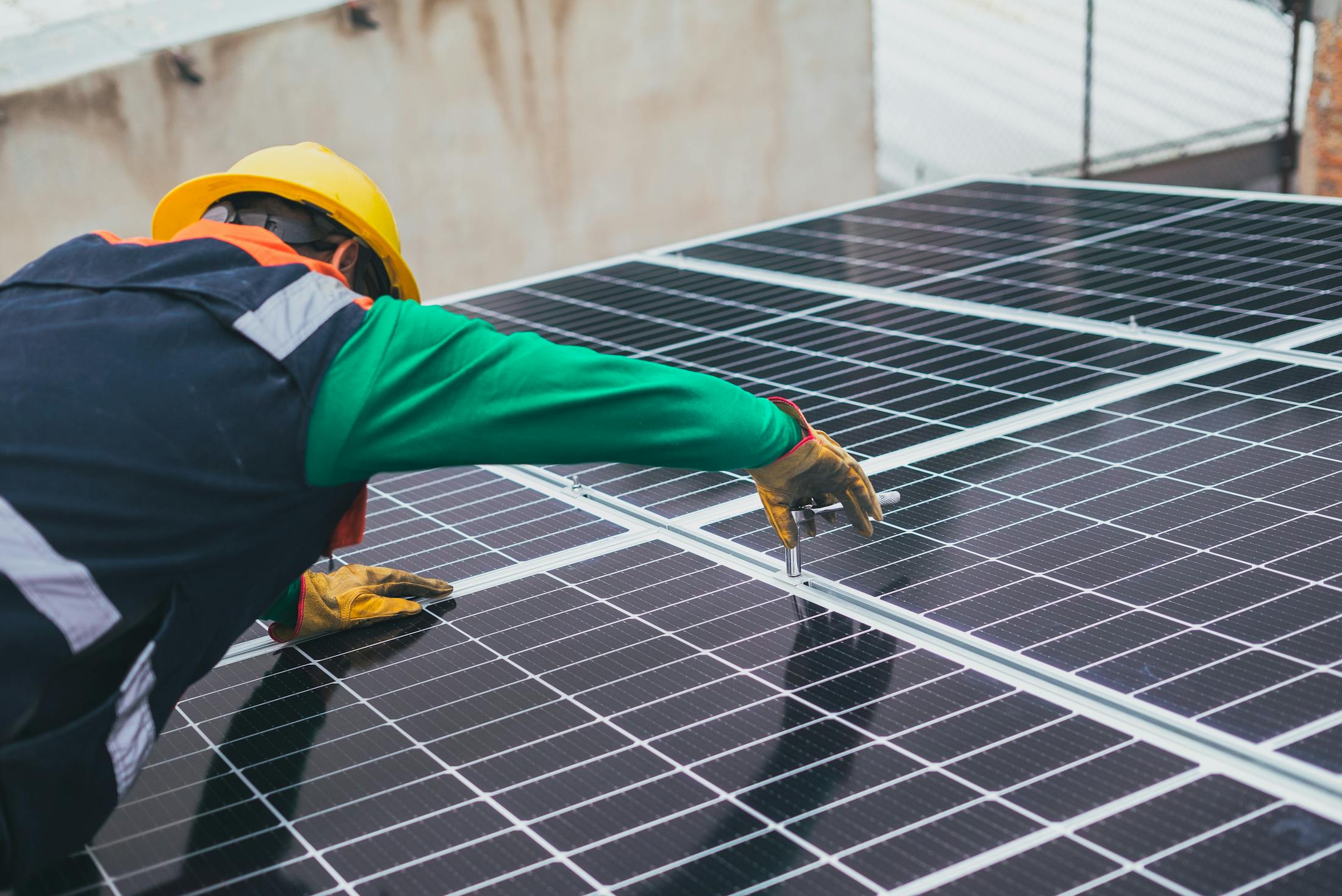 Tecnico installa pannelli solari su impianto industriale